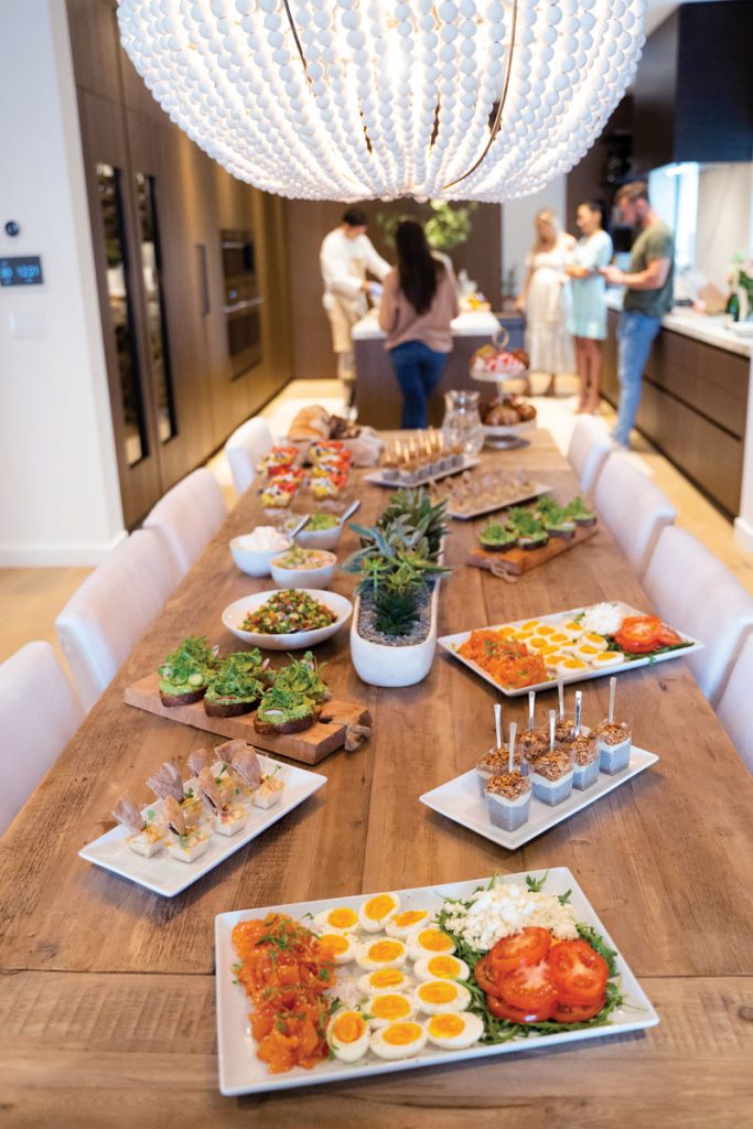 The couple’s kitchen was a hub of activity, with many attendees congregating there before filling their plates. The space includes a table made from an old door and a beaded stone and ceramic chandelier.