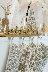 A silver and gold color theme added glam to stockings and decor, Photography by Jerry Rabinowitz