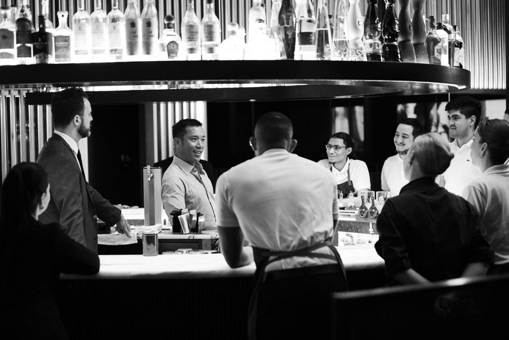 Kim and his staff gather around the bar at Cote. Photo by Tolga Kavut