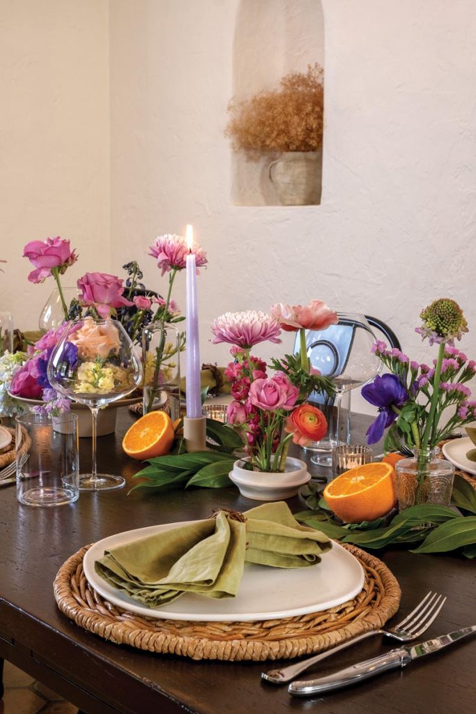 Amanda decorated their dining table with flowers, oranges, and candles. Photo by Jerry Rabinowitz