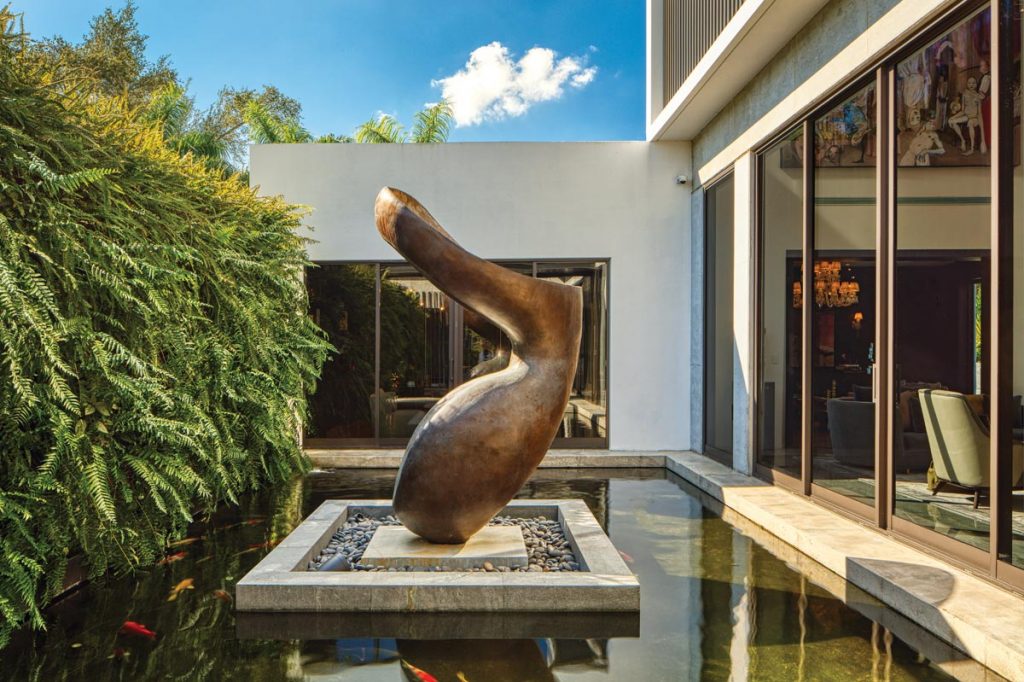 “[In this outdoor space], the dining room is centered on one half of the koi pond,” says Portuondo, “and the living room off the other. ”