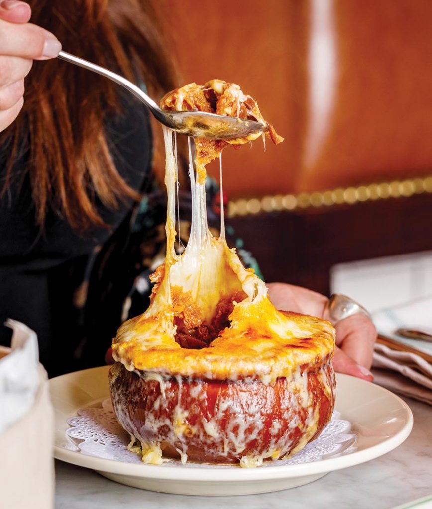 Pastis' onion soup bubbling over with gruyère. Photo by Joshua Perez