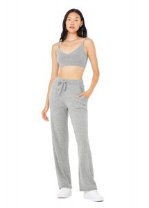 Cashmere Jet Set V-neck ($298), high-waisted wide-leg pants ($338), and bra ($150), Alo