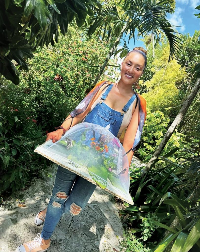 Kiki Sylvain carries a portable butterfly nursery dome at Patch of Heaven Sanctuary. Photo courtesy of Patch of Heaven Sanctuary