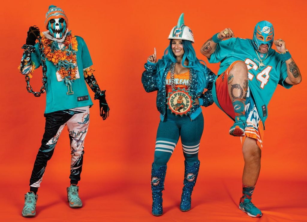 Fins Rider (aka Corey Sturgis), Dolphreaky (aka Allison Goodman), and FinSassin (aka Bob Sampson) agree: being part of the Dolphins fandom is a way of life. Photo by Steven Martine