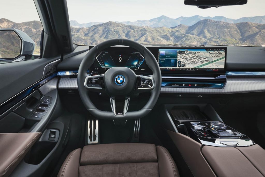 A wide-screen, curved-glass display sprawls across the dashboard. Photo courtesy of BMW