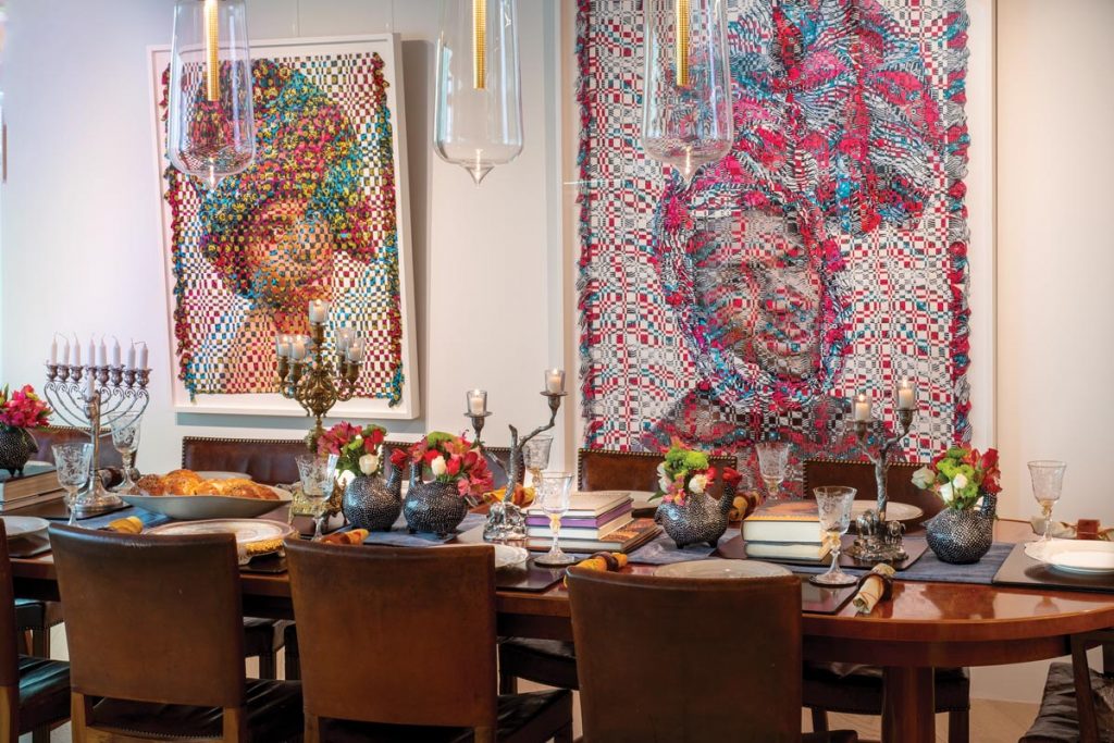 A pair of photographs by Kyle Meyer, made using a unique weaving technique, provide a dramatic backdrop for the Hanukkah table