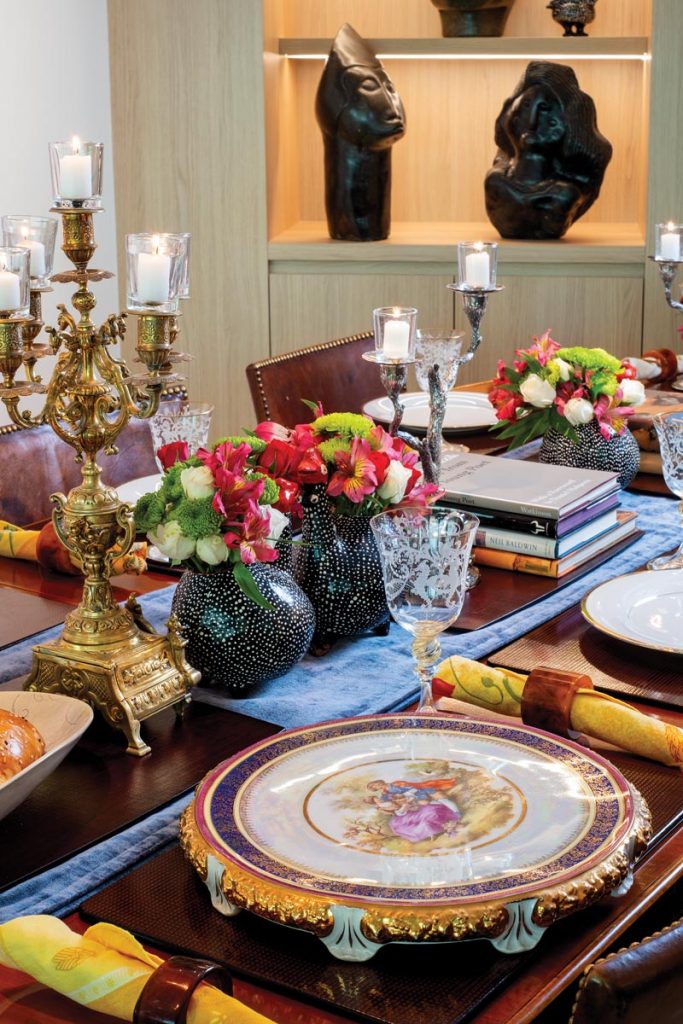 The table sparkled with Noritake china and crystal goblets from Venice, Italy. Additional accents included candelabras from Goldwasser’s grandfather, fired-clay guinea fowl vases from Zimbabwe, and linen napkins from Provence, France