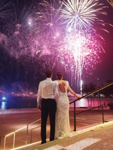 Claire Marie and Collier watch the fireworks at their wedding reception. Photo by Lorren & Braman Photography