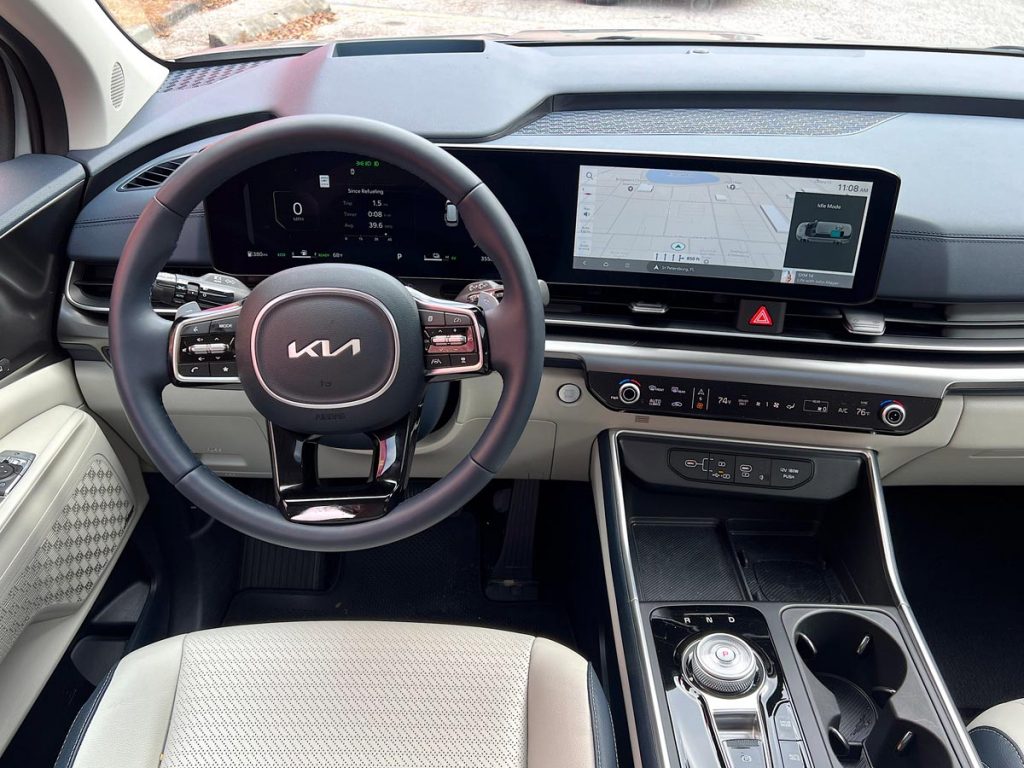 The dashboard and steering wheel in the Carnival Hybrid SX Prestige. Photo by Howard Walker