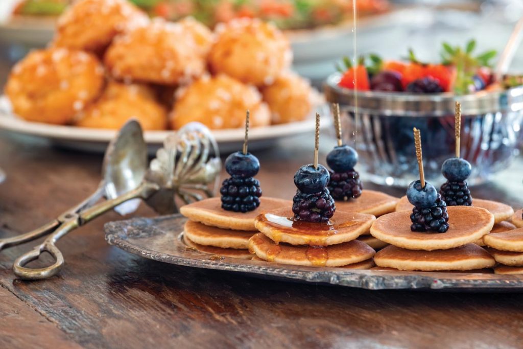 Mini pancake stacks on wood boards. Photo by Jerry Rabinowitz