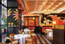 Slim’s Debuts in Bal Harbour Shops The indoor dining room features Art Deco murals by Christoph Niemann. Photo courtesy of Starr Restaurants